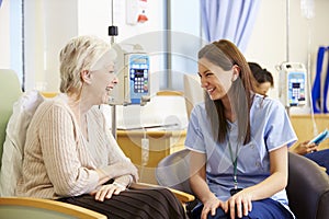 Senior Woman Undergoing Chemotherapy With Nurse
