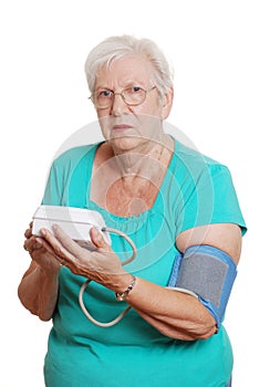 Senior woman use automatic blood pressure machine