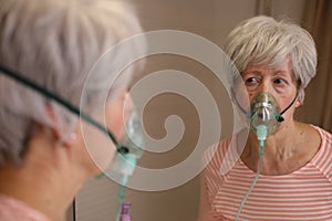 Senior woman using a breathing aid