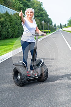 Senior woman using electric personal transporter