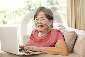 Senior Woman Using Laptop At Home