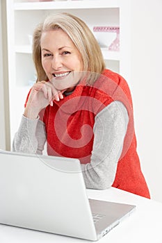 Senior Woman Using Laptop At Home