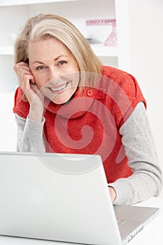 Senior Woman Using Laptop At Home