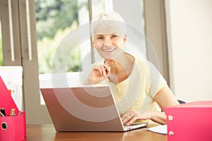 Senior Woman Using Laptop At Home