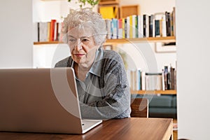 Senior woman using laptop at home