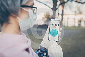 Senior woman using phone to get latest news on covid-19