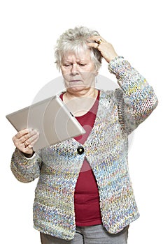 Senior woman using tablet computer looking confused