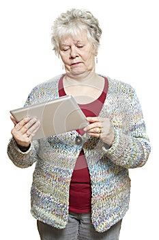 Senior woman using tablet computer looking confused