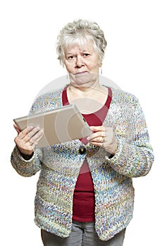 Senior woman using tablet computer looking confused