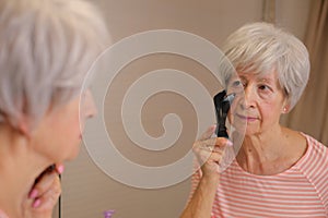 Senior woman using Threading as a method for hair removal