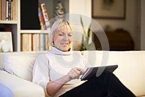 Senior woman using touch pad device