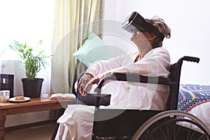 Senior woman using virtual realty headset at nursing home