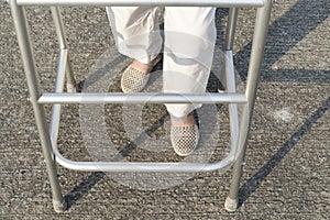 Senior woman using a walker .