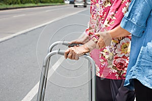 Senior woman using a walker cross street