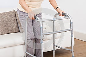 Senior woman using walking frame