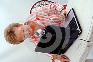 Senior woman using webcam