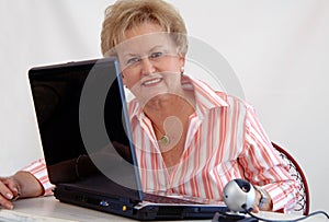 Senior woman using webcam