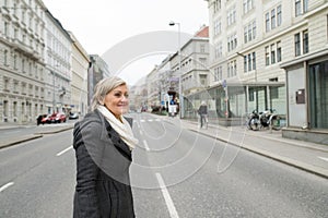 Senior woman on a walk in night city. Winter