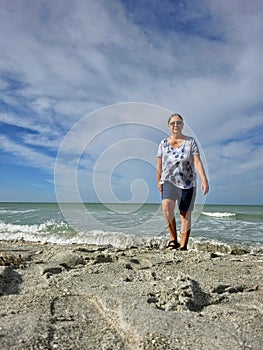 Senior woman walking on Captiva beach