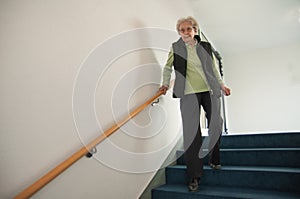 Senior woman walking down the stairs