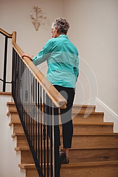 Senior woman walking up stairs