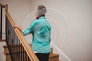 Senior woman walking up stairs