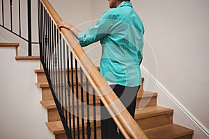 Senior woman walking up stairs