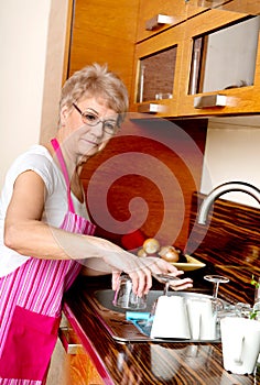 Senior woman washing dishes