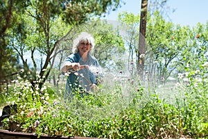 Senior Woman Watering her Garden