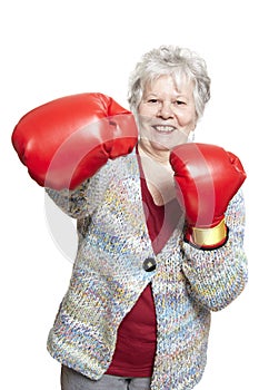 Senior woman wearing boxing gloves smiling