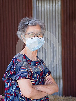 Senior woman wearing a face mask with a worried. Mask for protecting virus, coronavirus, pollen grains. Concept of aged people