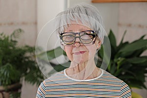 Senior woman wearing three eyeglasses simultaneously