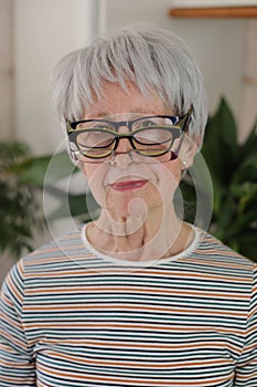 Senior woman wearing three eyeglasses simultaneously