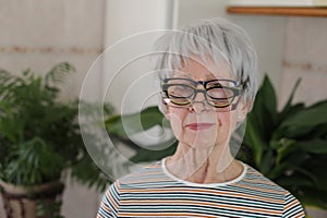 Senior woman wearing three eyeglasses simultaneously photo