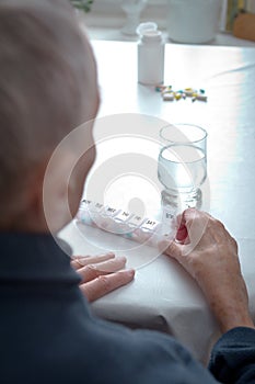 Senior woman weekly pill dispenser