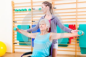 Senior woman in wheel chair doing physical therapy