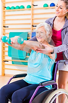 Senior woman in wheel chair doing physical therapy