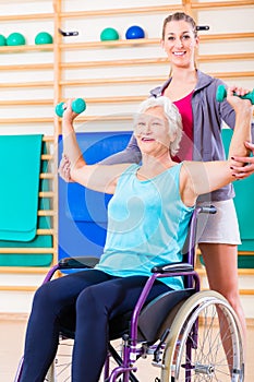 Senior woman in wheel chair doing physical therapy