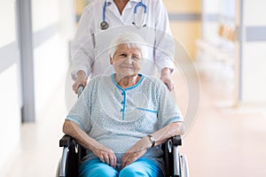 Senior woman in wheelchair with doctor in hospital