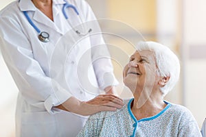 Senior woman in wheelchair with female doctor in hospital