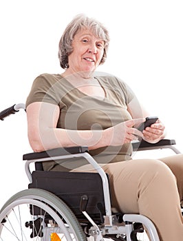 Senior woman in wheelchair using smart phone