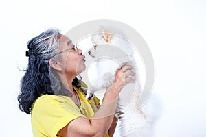 Senior woman with white Pomeranian dog