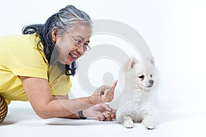 Senior woman with white Pomeranian dog