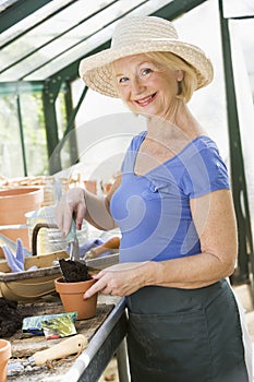 Senior woman working in greenhouse