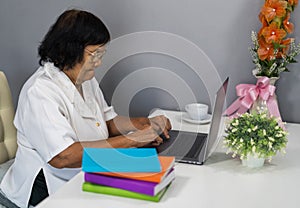 Senior woman working on laptop computer