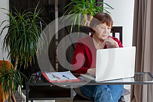 Senior woman working with laptop computer at home