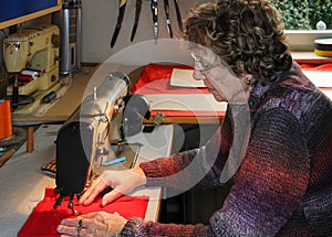 Senior woman working on a sewing machine