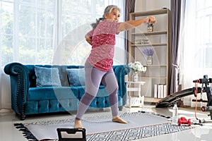 Senior woman workout with boxing jabs at home