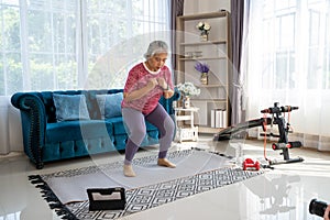 Senior woman workout for her knees with squat at home