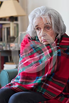 Senior Woman Wrapped In Blanket Unable To Afford Heating Bills